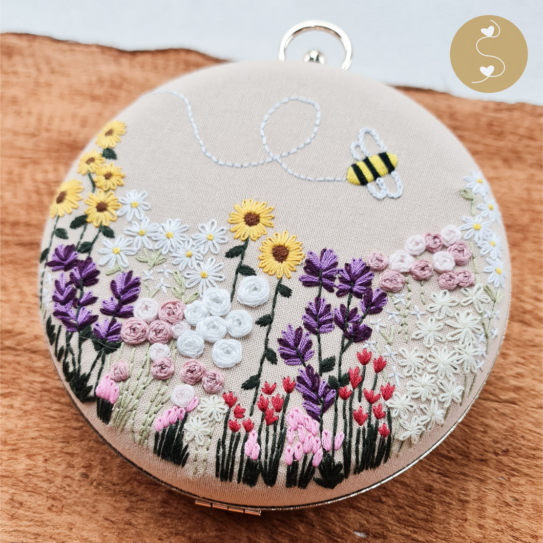 Joyhouseofseratku_This Marigold round-shaped cross-body bag is a fashionable and practical everyday accessory. The hand-embroidered bracelet strap and circle bag design make it the perfect crossbody clutch bag for beige and white evening events.