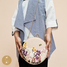 Load image into Gallery viewer, Joyhouseofseratku_This Marigold circle bag is handmade and features a round shape with a cross-body design. The long chain strap ensures easy transport, while the hand-embroidered details add a touch of luxury. Dress any look with this versatile white crossbody purse or carry it as a nude clutch bag.
